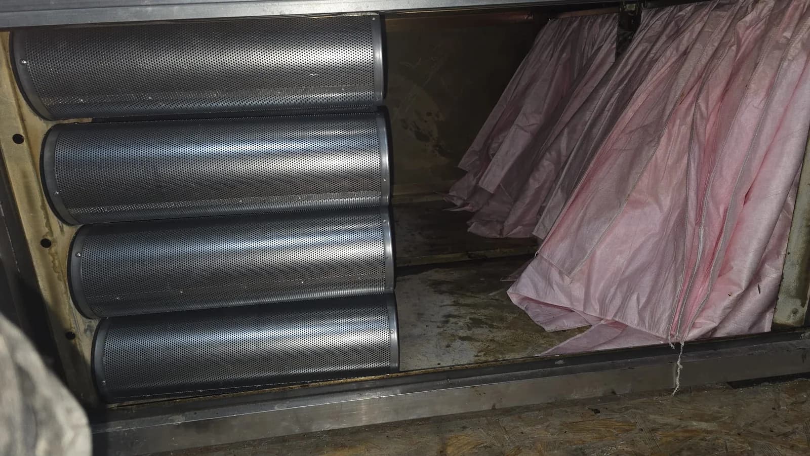 Odor control unit interior showing installed carbon cartridges and synthetic pre-filter.