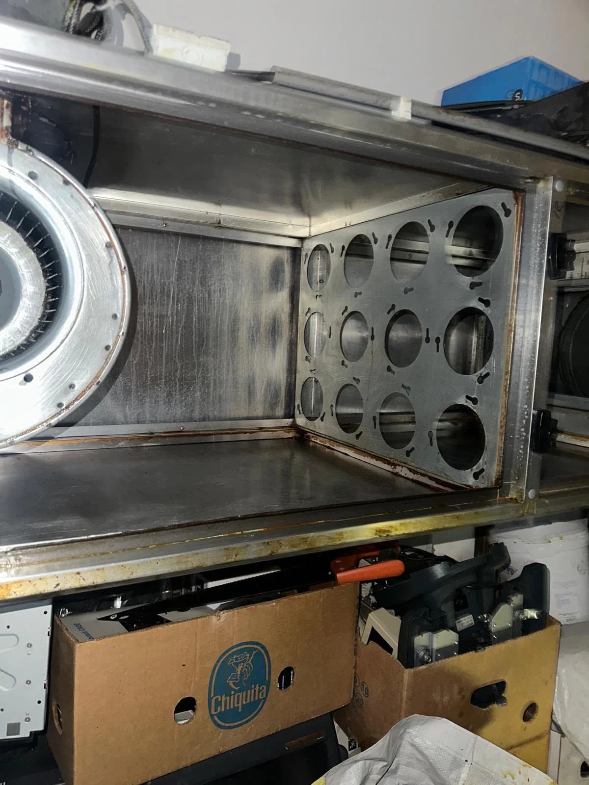 Empty mounting frame inside an odor unit prior to installing new carbon cylinders.