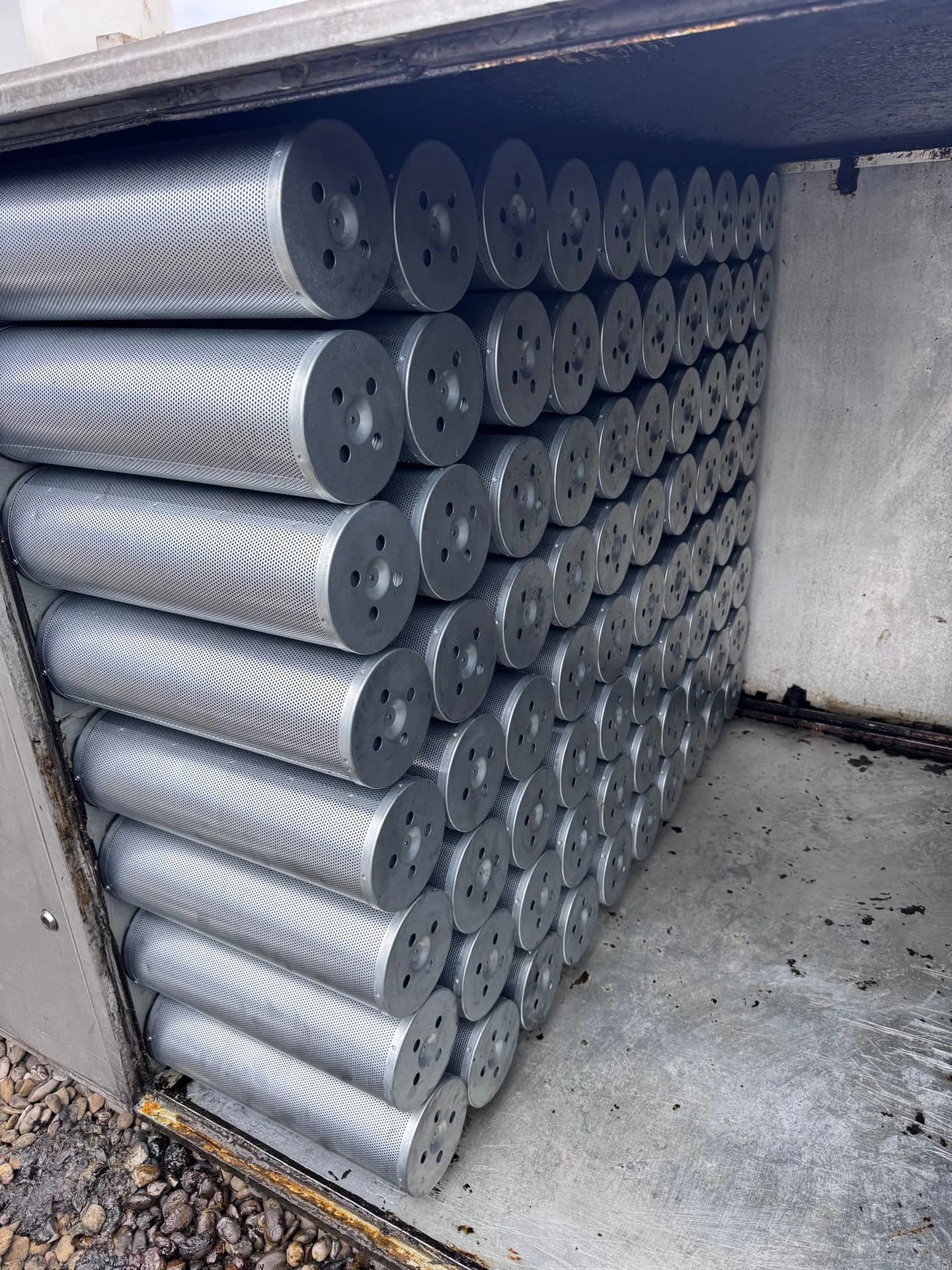 Large matrix of activated carbon filter cylinders installed inside a professional odor filtration unit.