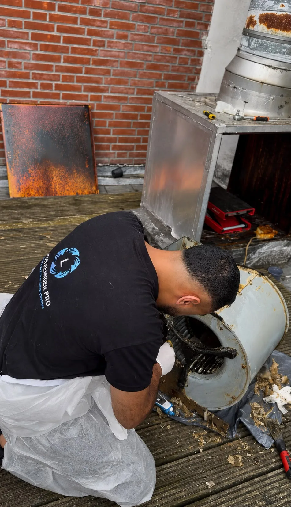 Specialist performing cleaning work on a professional installation on site.